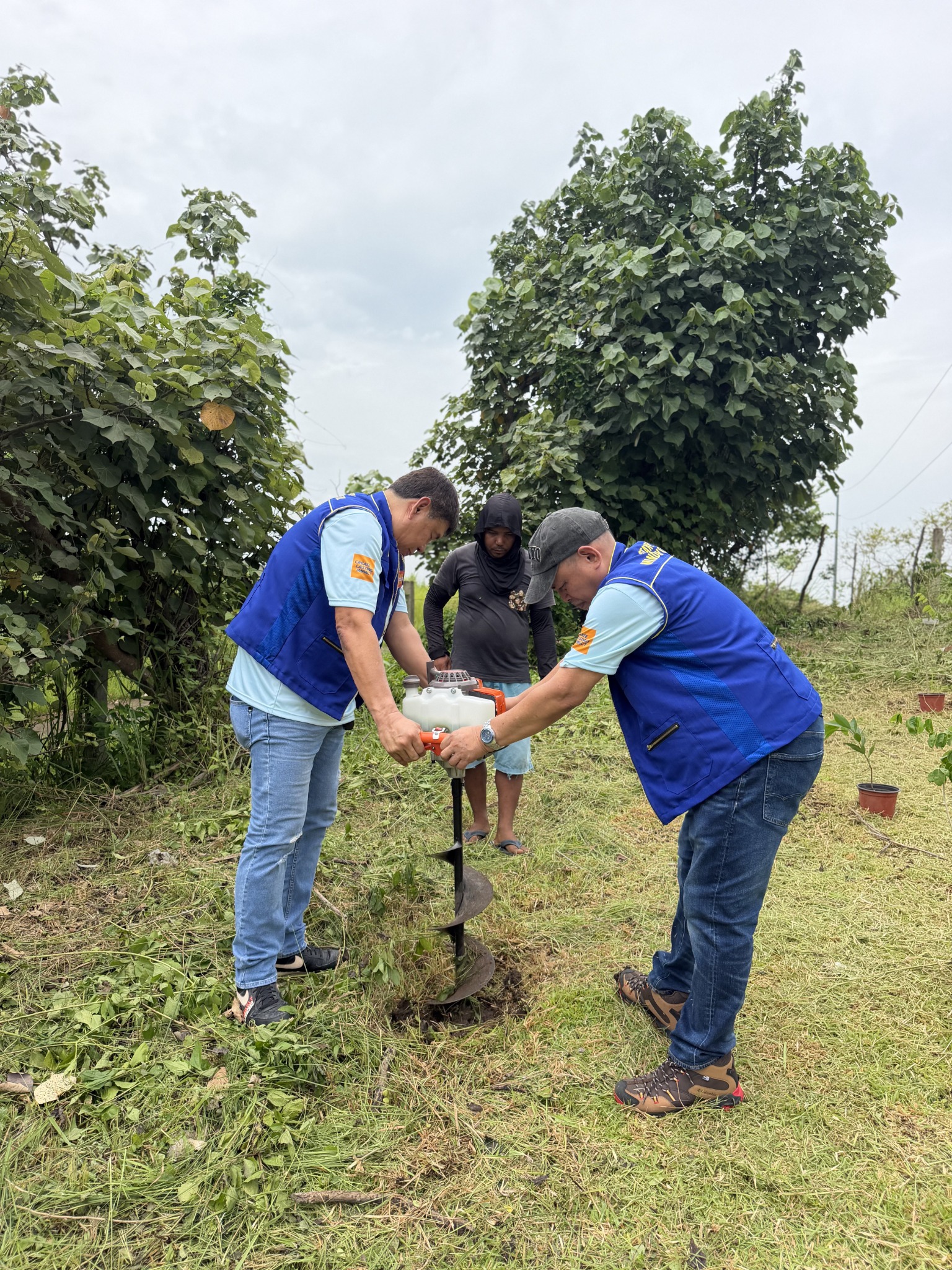RCMC volunteers preparing a planting hole during Project Green Legacy in Ikpan, Camarines Sur