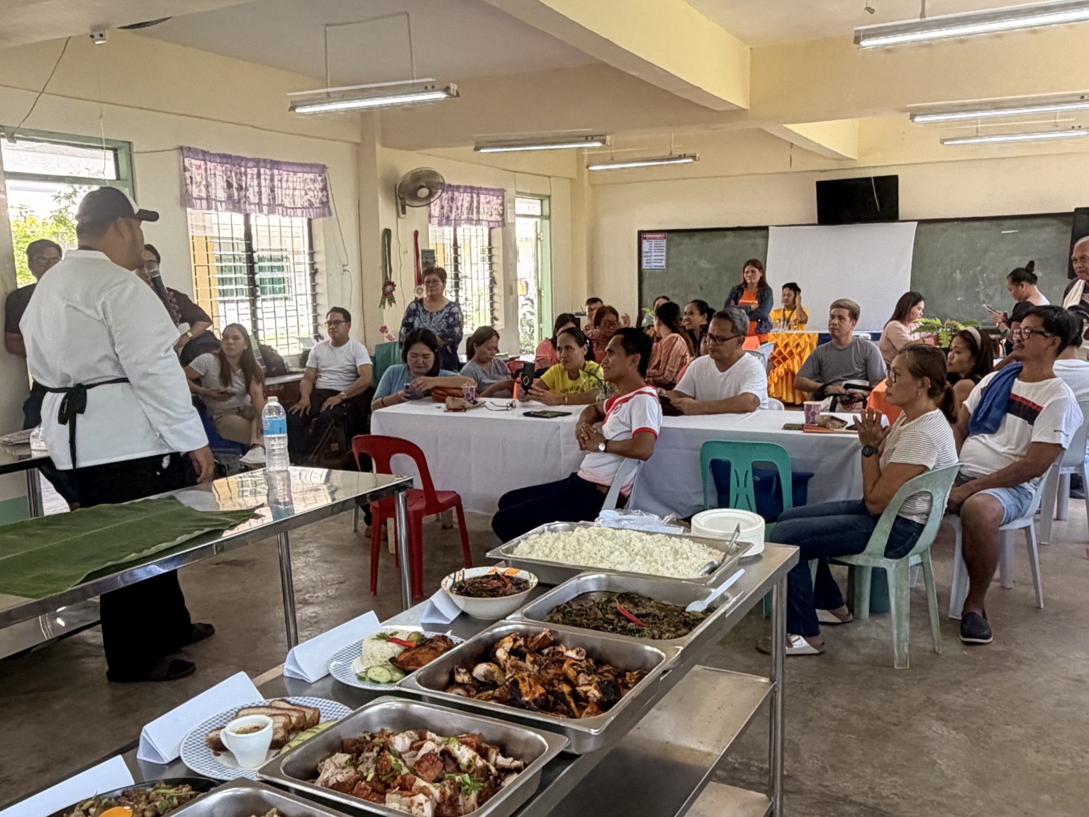 Participants observing finished dishes and restaurant operations