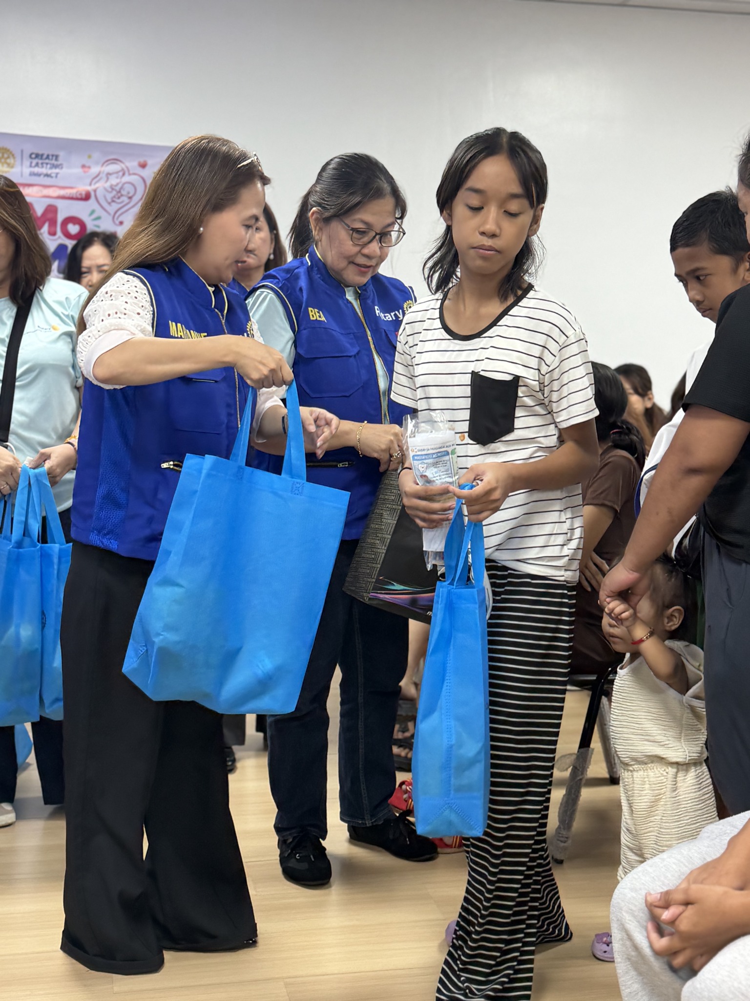 Rotary volunteers distributing Milk Mo, Love Mo support kits